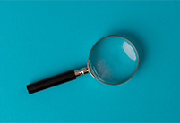 Magnifying glass on a teal blue background