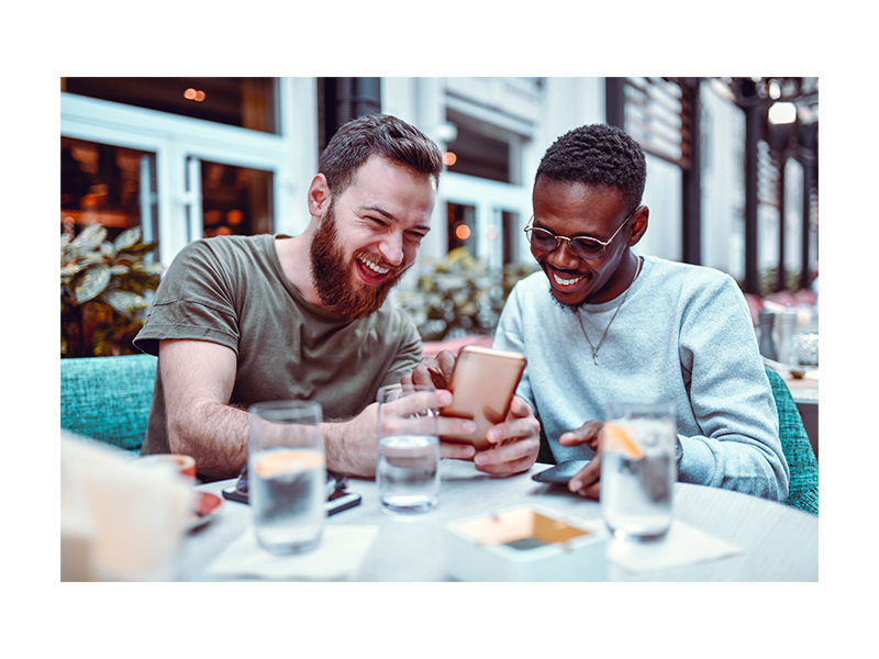 two friends looking at a phone