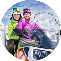 Couple on snow mobile.