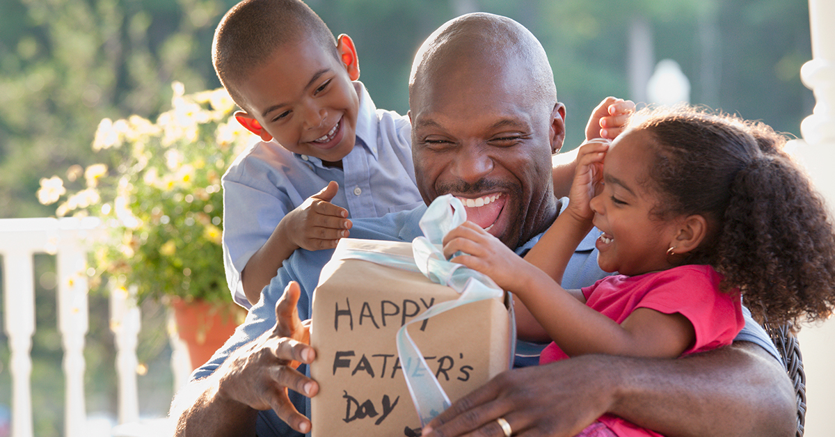 father's day gift giving outdoors with two kids