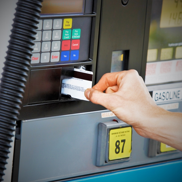 Customer inserts card to pay for gasoline at the pump.