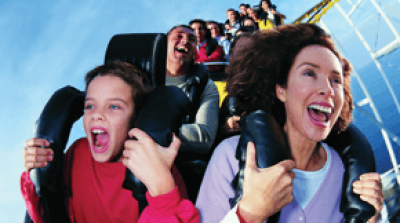 A boy and an older woman riding a rollercoaster.